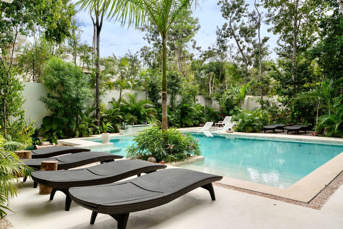 Lush tropical backyard pool with loungers - Estero, FL pool resurfacing service area