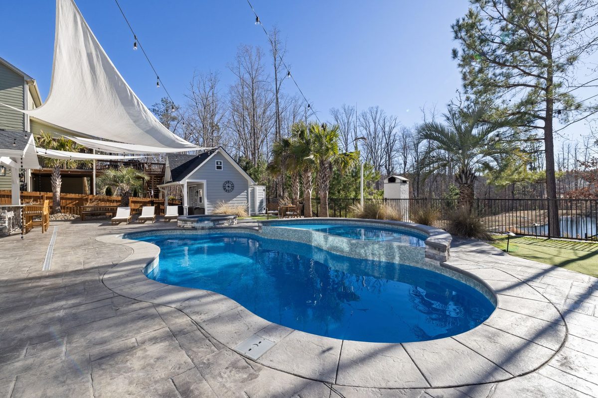 Freeform residential pool and spa on a stamped concrete deck - North Fort Myers, FL pool resurfacing service area